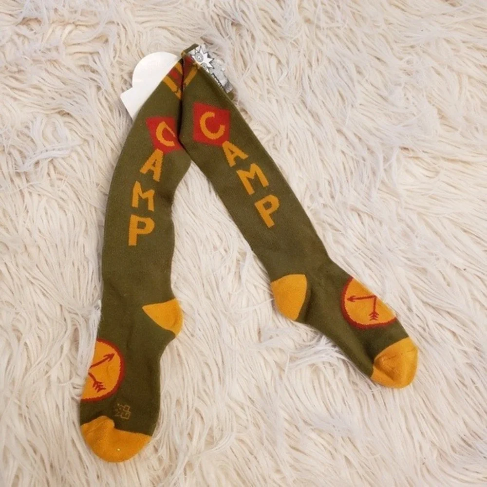socks that read Camp in gold letters‎